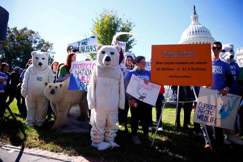 FILE PHOTO: Activists attend a protest against the legislation that would open Wilderness in Alaska to oil drilling on Capitol Hill in Washington, U.S. October 17, 2017. REUTERS/Eric Thayer/File Photo