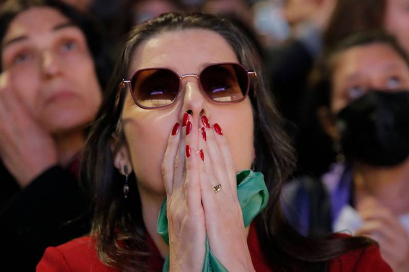 An anxious Lula supporter in Sao Paulo watches the results come in. Mr Bolsonaro and Lula are arch-rivals and traded insults during the campaign. AFP
