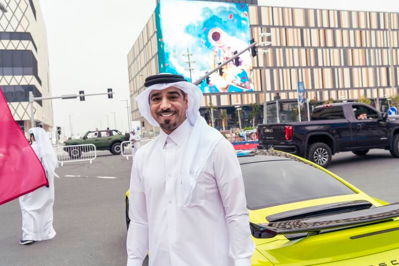 Car influencer Khalid Al Reminthi with his acid green Porche at Lusail Boulevard in Doha 