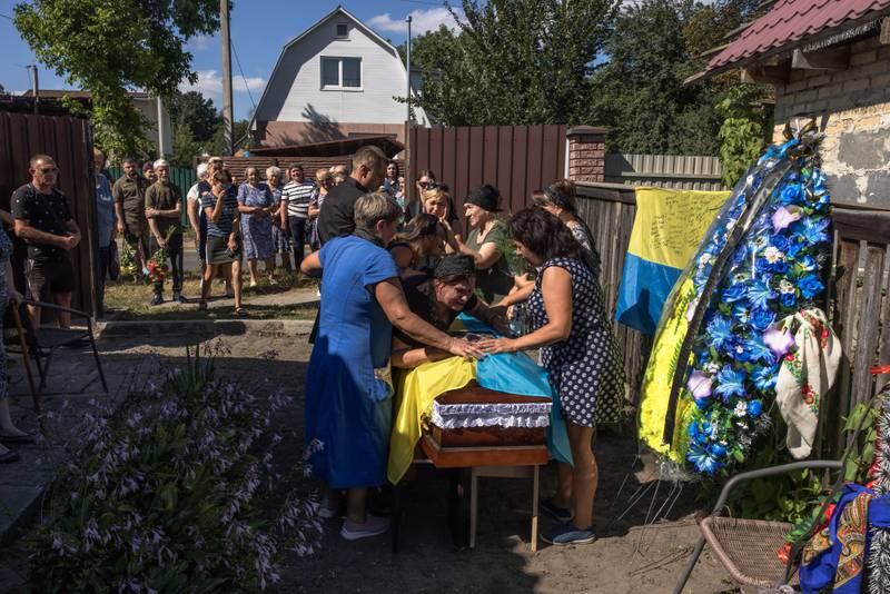 Kateryna, centre, the mother of the fallen Ukrainian soldier Andrii Dzyubenko, mourns along with other relatives, friends and comrades, during his funeral ceremony in Bucha, north-west of Kyiv, Ukraine.  EPA 