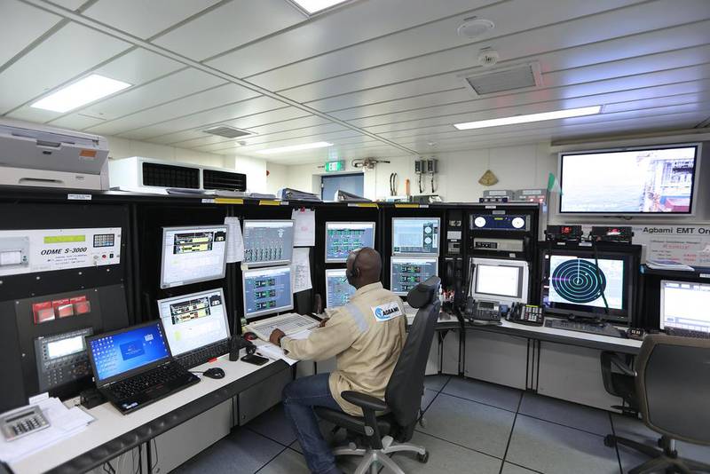 An oil worker monitors computers and television screens while working in the control room aboard the the Agbami floating production, storage and offloading vessel (FPSO), operated by Chevron Corp, in the Agbami deepwater oilfield in the Niger Delta, Nigeria. George Osodi / Bloomberg