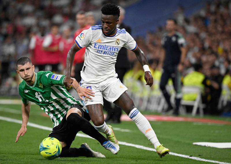 Real Madrid forward Vinicius Junior under pressure from Guido Rodriguez of Real Betis. AFP