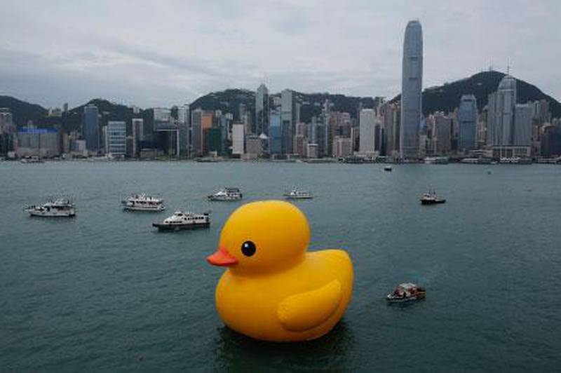 A giant Rubber Duck created by Dutch artist Florentijn Hofman is towed along Hong Kong's Victoria Habour.