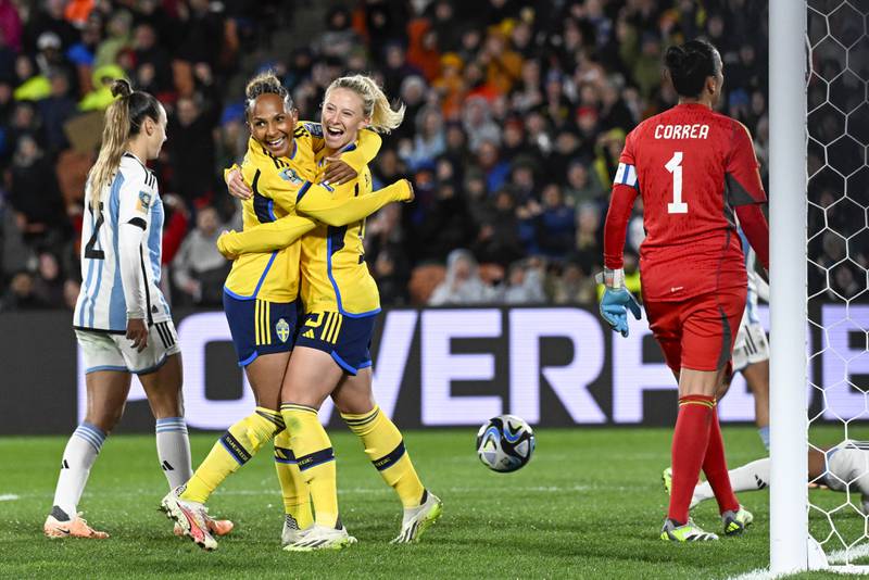Sweden's Rebecka Blomqvist, centre, embraces teammate Madelen Janogy after scoring against Argentina. AP