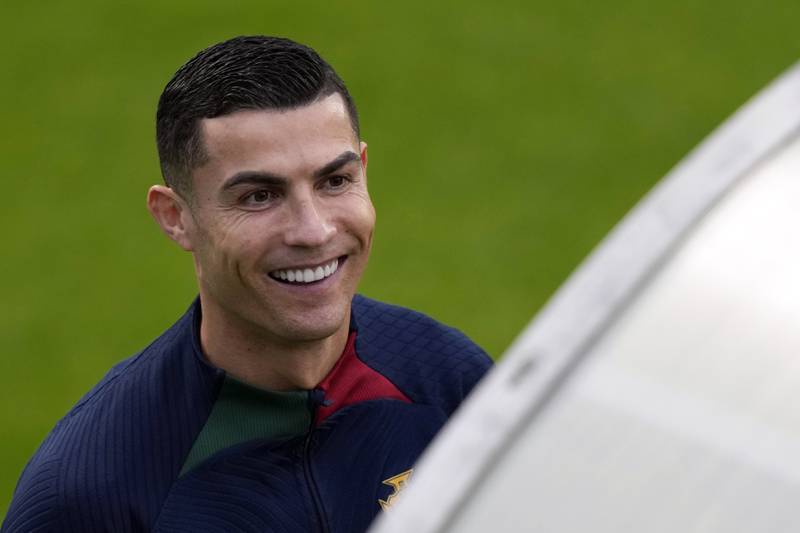Cristiano Ronaldo smiles as he arrives for a team training session in Oeiras, outside Lisbon. AP Photo