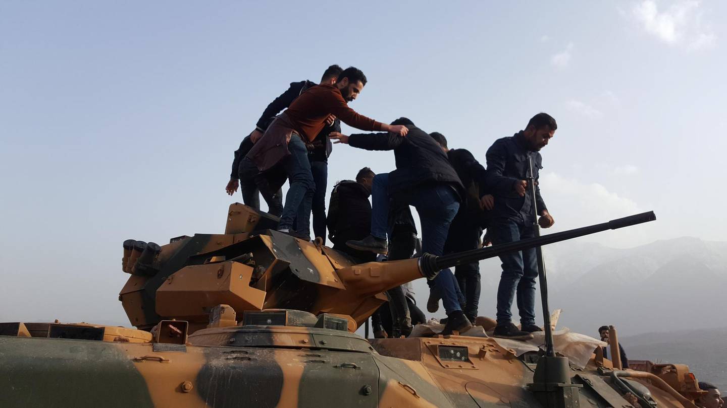 Protesters stand on a Turkish tank after they stormed a Turkish military camp near Dohuk, Iraq January 26, 2019.  REUTERS/Stringer  NO RESALES. NO ARCHIVES