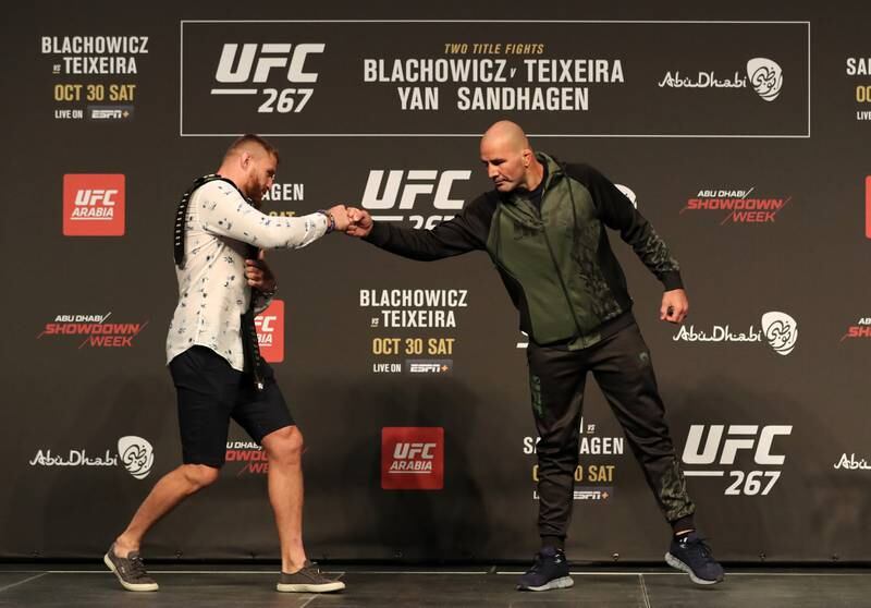 Jan Blachowicz (L) and Glover Teixeira shake hands at the press conference before UFC 267.