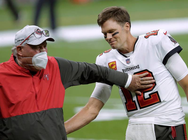 Tampa Bay Buccaneers coach Bruce Arians, left, speaks with quarterback Tom Brady before the team's NFL divisional round playoff football game against the New Orleans Saints on January 17. AP
