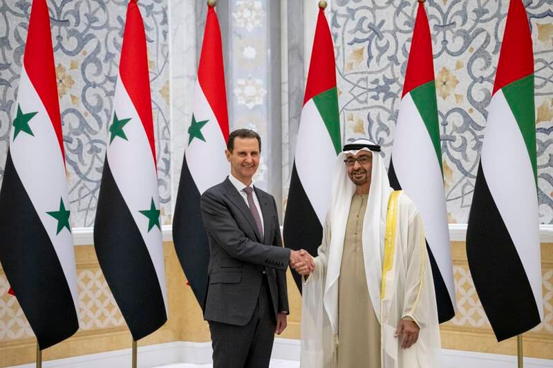 Sheikh Mohamed shakes hands with Mr Al Assad. Presidential Court