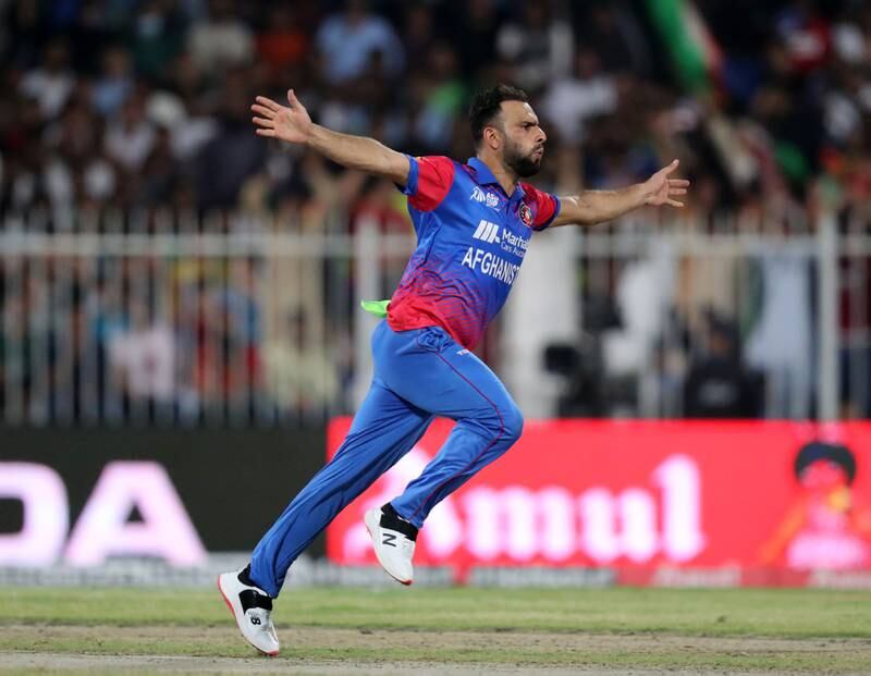 Afghanistan's Fareed Ahmad celebrates after taking the wicket of Pakistan's Haris Rauf.