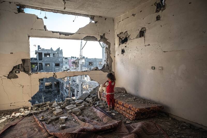 A Palestinian girl stands amid the rubble of her home destroyed by Israeli air strikes on May 24, in Beit Hanoun, Gaza. Getty Images