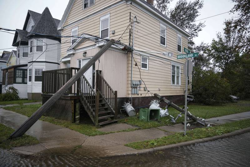 Power lines damaged by Fiona rest against a home in Sydney, Nova Scotia. AFP
