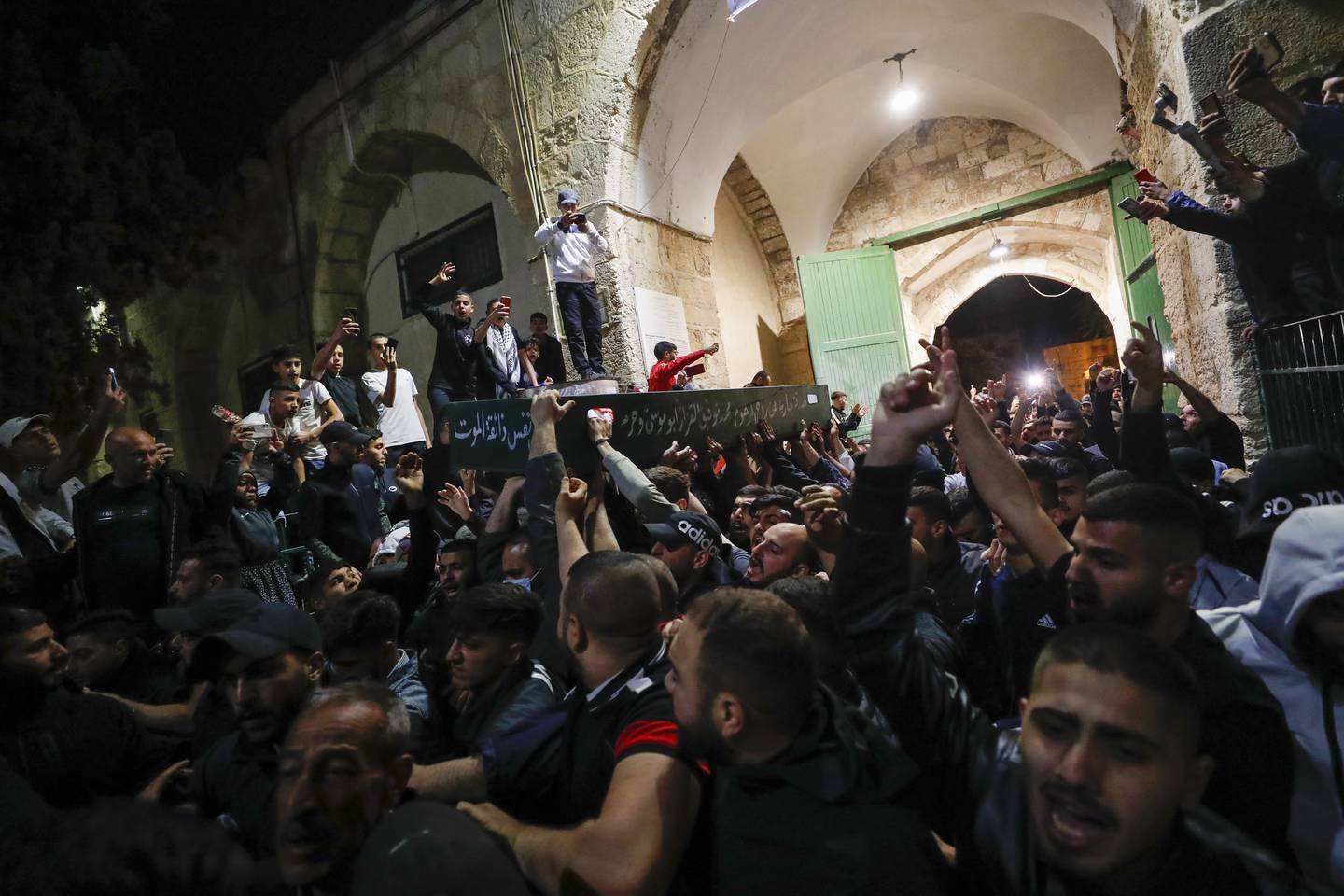 Palestinian mourners carry the coffin of Walid Shareef during his funeral at Al Aqsa Mosque compound in Jerusalem's Old City. EPA
