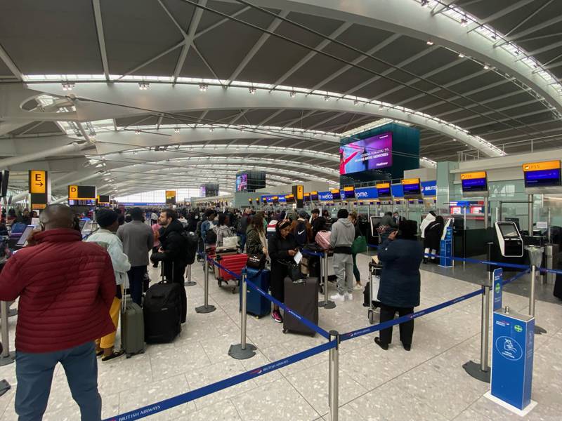 People queue to check-in at Heathrow Terminal 5. PA