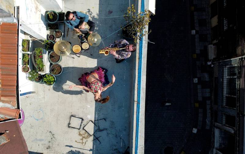 An aerial view of the performance of dancer Su Sevda Uzun from a terrace of her friend's home while she is accompanied by musicians Hakan Kaya and Alper Kalayciklioglu, in Istanbul, Turkey. Reuters
