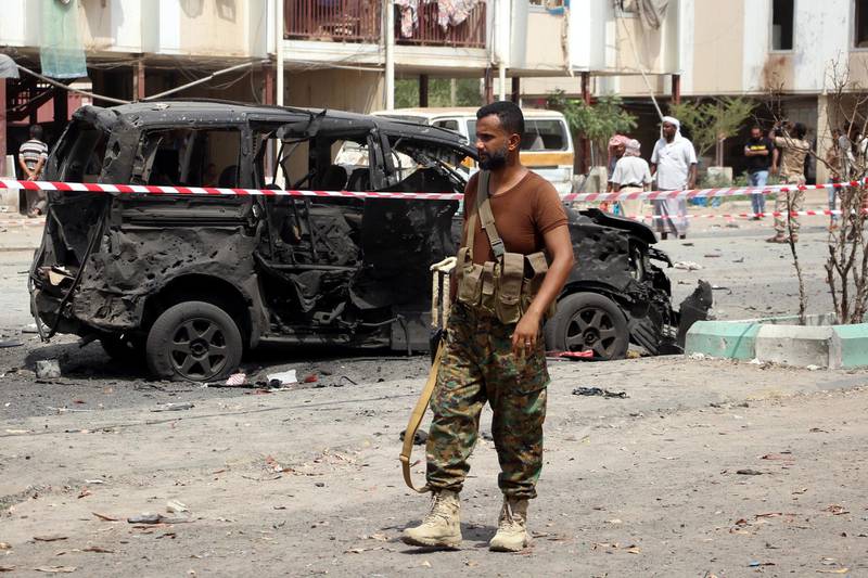 A Yemeni soldier stands guard at the site of a car bomb attack.  EPA