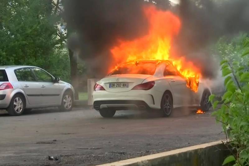 This frame grab provided by BFM TV shows a car burning in Dijon, central France, Monday June 15, 2020. The French government sent police reinforcements and a top official to the Dijon region to quell four nights of unusually violent clashes between rival groups that have left at least 10 injured and cars burned and rattled the community. The reasons for the violence are under investigation, but local officials say it appears linked to the drug trade and tensions between members of France's Chechen community and other groups. (BFM TV via AP)