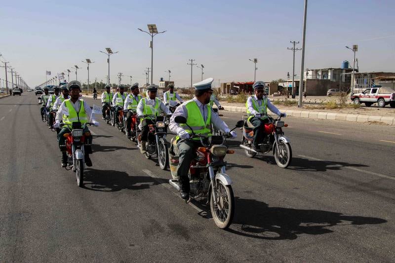 Traffic police escort Taliban forces as they rally to celebrate the withdrawal of US forces in Kandahar, Afghanistan.  EPA