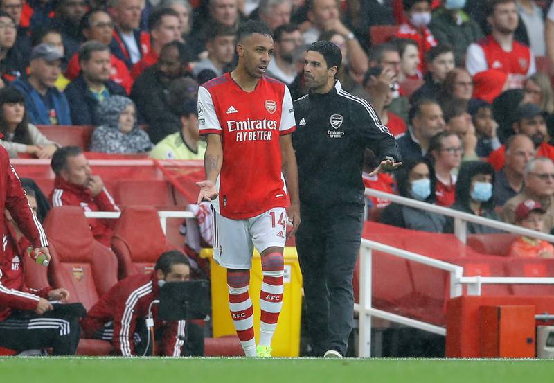 Arsenal's Pierre-Emerick Aubameyang talks with manager Mikel Arteta before the striker comes on as a substitute. Reuters