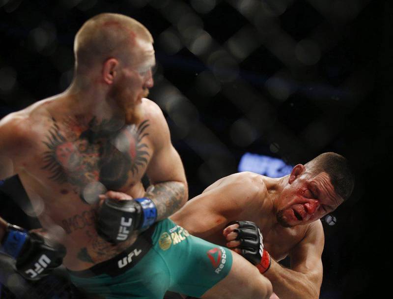 Conor McGregor, left, kicks Nate Diaz during their welterweight clash at UFC 202 in 2016. AP