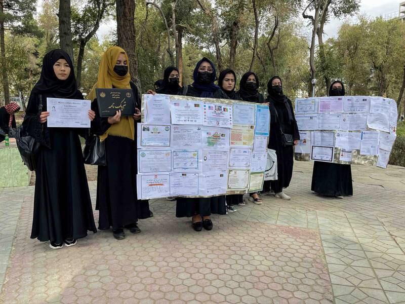 Afghan women show their education certificates at a protest to demand job opportunities in Kabul.  EPA
