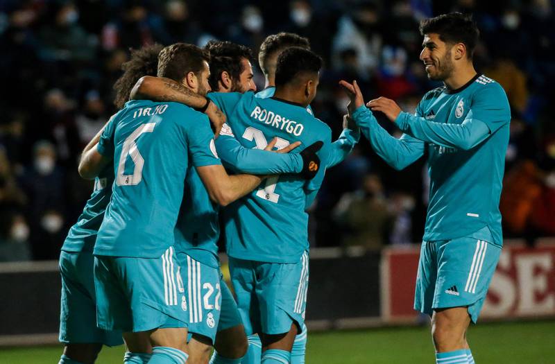 Real Madrid midfielder Isco celebrates with teammates after scoring his side's third goal, though it was later credited as a Jose Juan own goal. AFP