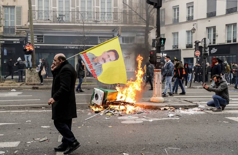A man carries a flag showing the face of Abdullah Ocalan, the founder and leader of the PKK, at a protest in Paris on Saturday. EPA