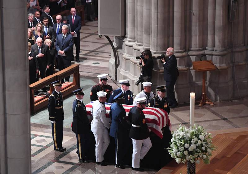 A Military Honor Guard carries the casket of US Senator John McCain into the Washington National Cathedral.  AFP