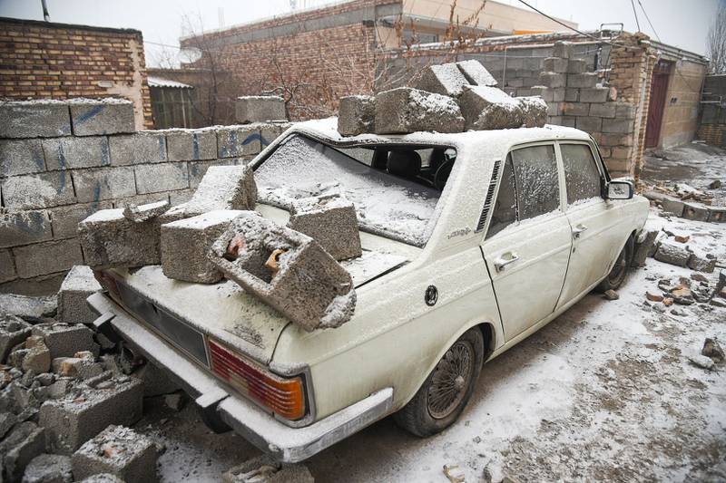 A vehicle covered by rubble. AFP
