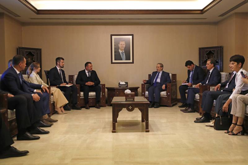 Syrian Foreign Minister Faisal Mekdad, centre right, in talks with a Russian delegation led by Duma member Dmitry Sablin, centre left, in Damascus on June 14. Syria has recognised two Moscow-backed separatist states in Ukraine as independent. AP