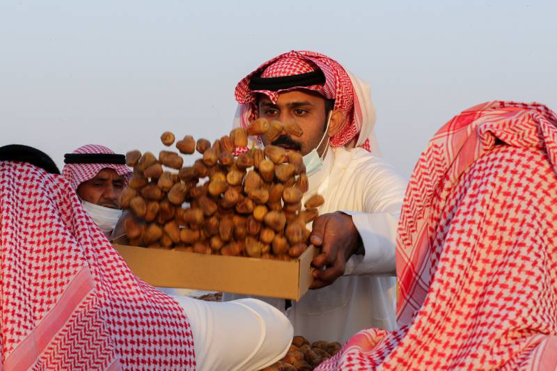 A Saudi farmer displays dates to customers.
