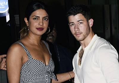 (FILES) In this file photo taken on June 22, 2018, Indian Bollywood actress Priyanka Chopra (L) and US singer Nick Jonas stand together in Mumbai. Chopra is engaged to Jonas after a whirlwind two months of dating, People magazine, citing unnamed sources close to the pair, reported on July 27, 2018. / AFP / -
