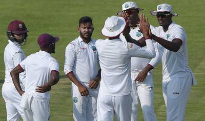 West Indies players celebrate a wicket against Pakistan on Sunday during Day 1 of the third Test in Sharjah. Aamir Qureshi / AFP / October 30, 2016