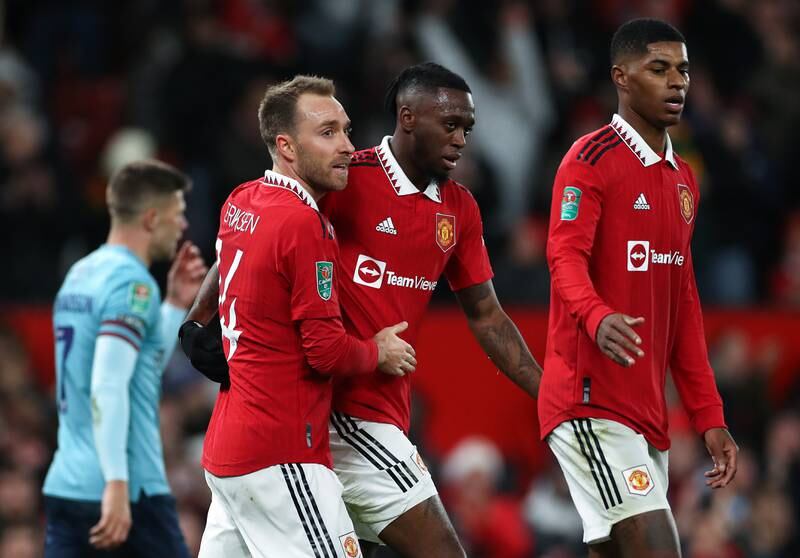 Manchester United's Christian Eriksen, left, celebrates scoring the first goal with teammates Aaron Wan-Bissaka and Marcus Rashford, right. Getty