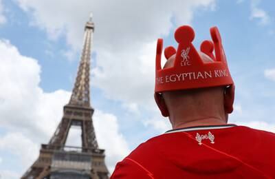 A Liverpool fan is pictured in front of the Eiffel Tower. Reuters