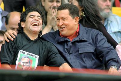 Venezuelan President Hugo Chavez (R) jokes with Argentinian former soccer star Diego Armando Maradona during the "People's Summit" massive rally against the IV Summit of the Americas, in Mar del Plata's stadium 04 November 2005. During the rally, activists will stress their opposition to the Free Trade Area of the Americas (ALCA, in spanish) and the visit of US President George W. Bush. On arrival in Mar del Plata, Chavez said "the FTAA is dead and we are going to bury it here." (Photo by STR / AFP)