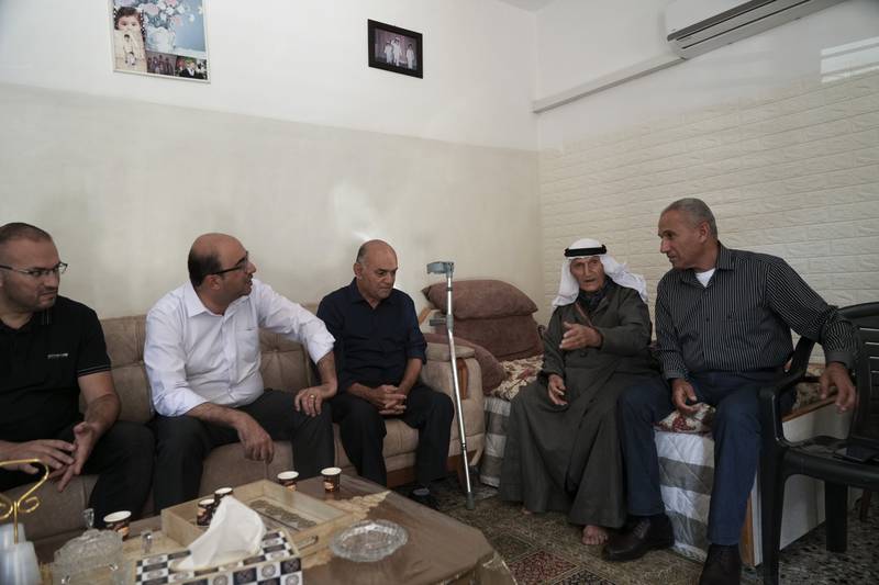 Knesset member Sami Abu Shehadeh, second left, head of the nationalist Balad party, meets Israel's Palestinian citizens during his election campaign tour in Musmus village. AP
