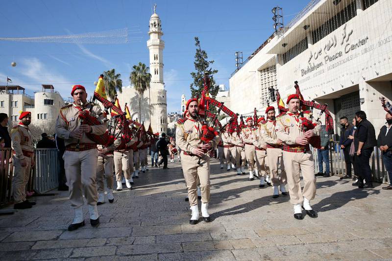 Palestinian scout bands perform as they parade during celebrations for Christmas outside the Church of the Nativity in the West Bank city of Bethlehem. EPA