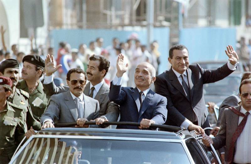 From L to R: North Yemeni President Ali Abdullah Saleh, Iraqi President Saddam Hussein, Jordanian King Hussein and Egyptian President Hosni Mubarak, wave to the crowd, on June 15, 1989 during a motorcade rally prior to the opening of the Arab Cooperation Council in Alexandria, Egypt. (Photo by Mike NELSON / AFP)