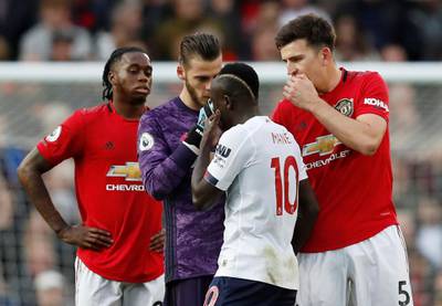 Manchester United's Harry Maguire and David de Gea remonstrate with Liverpool's Sadio Mane, who had a goal ruled out by VAR for handball. EPA