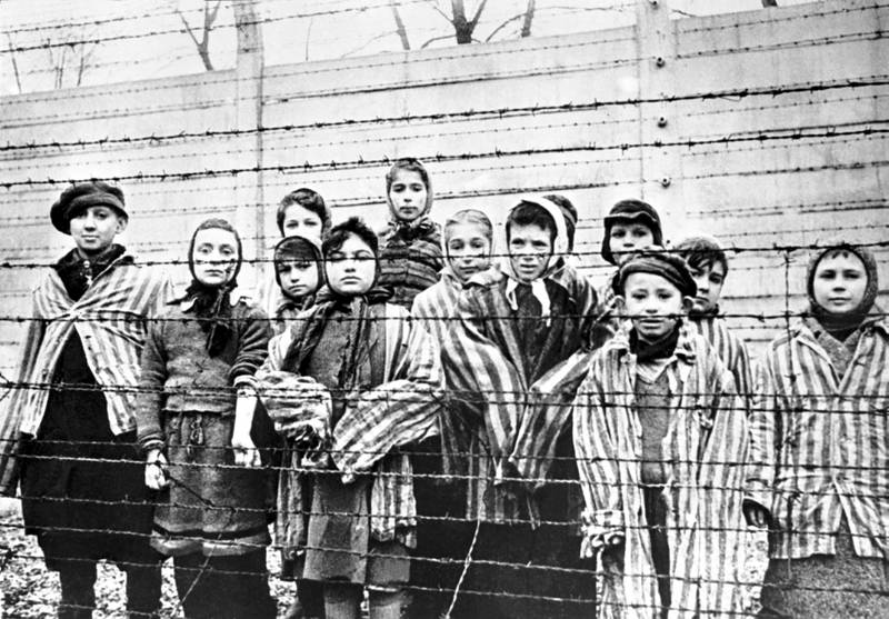 A group of children behind a barbed wire fence at Auschwitz-Birkenau on the day of the camp’s liberation by the Russian army, January 27, 1945. Getty Images