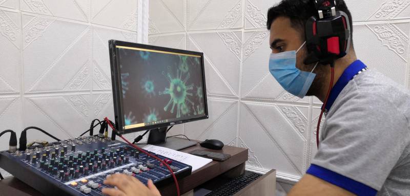 An employee from the ministry of health during a radio broadcast that offers advice about the coronavirus precautionary measures at a radio station in Basra, Iraq. Reuters
