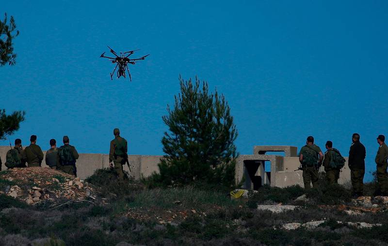 Israeli soldiers look at a drone prepared to throw gas canisters during clashes with Palestinian protestors in Ramallah. APF