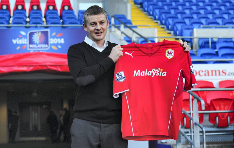 CARDIFF, WALES - JANUARY 02:  Ole Gunnar Solskjaer holds aloft the club shirt after being unveiled as the new Cardiff City Manager at Cardiff City Stadium on January 2, 2014 in Cardiff, Wales.  (Photo by Stu Forster/Getty Images)