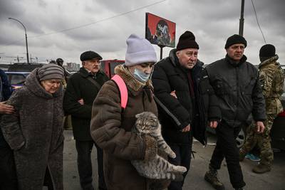 Ukrainian people flee the city of Irpin, north-west of Kyiv. AFP