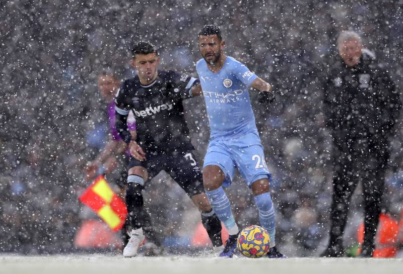 Manchester City's Riyad Mahrez, right, duels for the ball with West Ham's Aaron Cresswell. AP