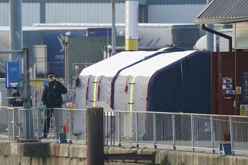 Forensic tents at the lifeboat rescue station are set up at the port. AP