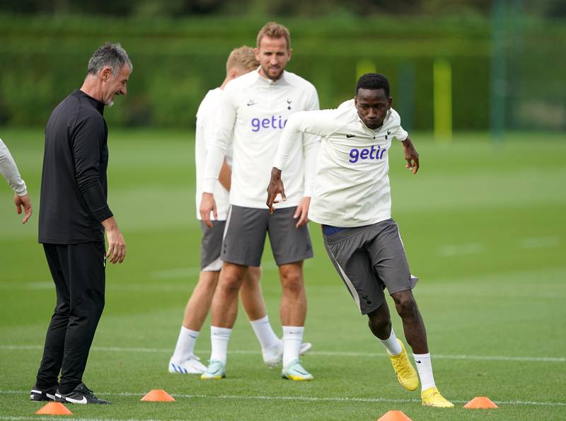 Tottenham's Pape Matar Sarr and Harry Kane during training. PA