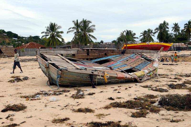 A young boy walks past a fishing boat that was destroyed when Cyclone Kenneth struck in Pemba city on the northeastern coast of Mozambique.  Cyclone Kenneth arrived late Thursday, just six weeks after Cyclone Idai ripped into central Mozambique and killed more than 600 people. AP