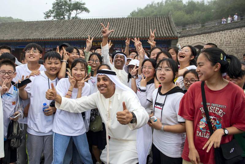 One of the men poses with Chinese onlookers. Courtesy WAM